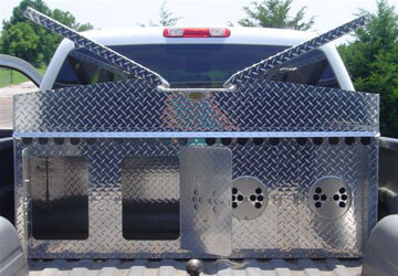 Aluminum dog box in the back of a pickup truck